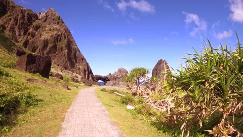 13147 slow motion hand hold camera view look out to Lover's cave in Lanyu walkin Stock Footage 346379546