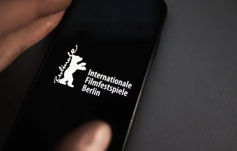 Berlin International Film Festival logo on smartphone screen. High quality photo. xkwx 2020, advertisement, architecture, art, atmosphere, award, background, bear, beautiful, berlin, berlin international film festival, berlinale, berlinale bear, cinema, colorful, competition, concert, creative, culture, design, entertainment, europe, event, february, festival, film, film market, fire, germany, golden, illustrative editorial, industry, international, logo, logotype, modern, movie, music, opening, people, poster, premiere, programme, screen, sign, smartphone, symbol, theater, tourism