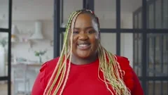 Lovely obese african woman with afro braids smiling