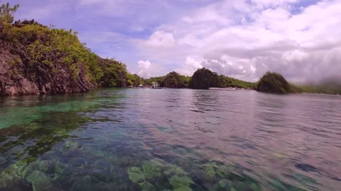 13246slow motion at the surface of ocean water look out to a small hut in crysta Stock Footage 338125034