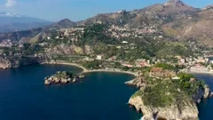 Taormina is a city on the island of Sicily, Italy. Mount Etna over Taormina c