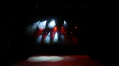 Free stage with red lights, lighting devices, smoke fog.