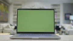 Home office. Green screen laptop computer sitting on a kitchen island