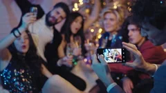Charismatic group of students taking pictures at new year party they celebrating