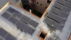 Aerial: Flyover rooftop solar panels