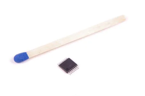 14 lead TSSOP electronics component chip in comparison with match head Stock Photos