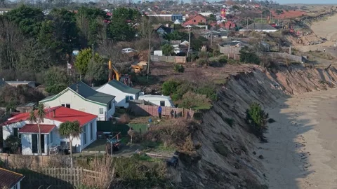 14/01/2026. Hemsby, Norfolk, UK.  Pull-back drone shot of condemned Hemsby homes Stock Footage 326900069