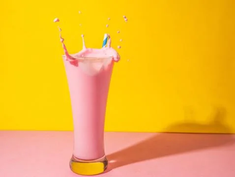 A  glass  of  strawberry  smoothie  isolated  on  yellow  and  pink  background xkwx fruit,  diet,  berry,  strawberry,  drink,  healthy,  nutrition,  food,  fresh,  blended,  vitamin,  milkshake,  background,  summer,  smoothie,  sweet,  dessert,  refreshment,  juicy,  juice,  glass,  pink,  isolated,  straw,  beverage,  horizontal,  yellow
