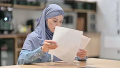 Professional Arab Woman Reading Documents at Work