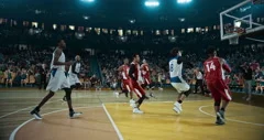 Basketball player scores a goal on a professional basketball stadium.