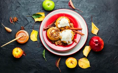 Baked apples stuffed with granola and nuts.Baked apples with nuts xkwx apple baked stuffed nut dessert autumn oatmeal filled food ice cream fruit baked apple sweet cinnamon plate delicious fall caramel syrup sugar walnut tasty ice cream bake caramel season dish syrup sauce eat prepared cinnamon stick table scoop fallen leaves seasonal tempting granola appetizing stuffed apples flat lay