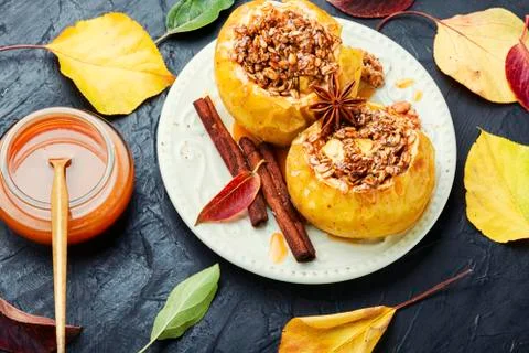Baked apples stuffed with granola and nuts.Baking concept xkwx apple baked stuffed nut dessert autumn oatmeal filled food fruit dessert fruit baked apple sweet cinnamon plate delicious fall homemade sugar walnut tasty bake stuffed apple sweetness caramel season dish syrup sauce eat prepared cinnamon stick table caramel syrup scoop fallen leaves seasonal tempting granola appetizing stuffed apples