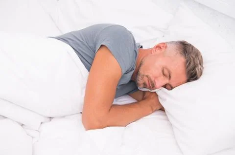Relaxed man. Promote prevention and management of sleep disorders. World Sleep Day. Benefits of good and healthy sleep. Breathe Easily, Sleep Well. Handsome man in bed. Sleeping guy at home. xkwx sleeping, relaxed, man, home, sleep, sleepy, asleep, healthy, promote, prevention, management, disorders, world, benefits, good, breathe, easily, well, handsome, bed, guy, adult, concept, drowsy, face, fall, feel, get up, lying, morning, pillow, problems, relax, relaxation, rest, sleep disorder, techniques, time, tired, try, unshaven, wake up, wakefulness, handsome man, healthy sleep, sleeping man, bedroom, alone