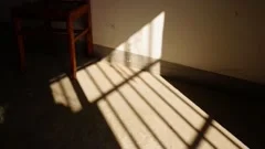 Shadow of window in sunlight moving on the wall and concrete floor, time-laps