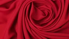 Background of red textile folded pleats spinning