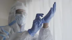 An Indian doctor or healthcare worker in PPE kit wearing hand gloves