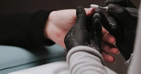 14master in black gloves making manicure using electric equipment for nails. Stock-Footage 149365804