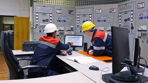 15 0505 TwoEngineersTalkLookingMonitor Stock Footage 105461752