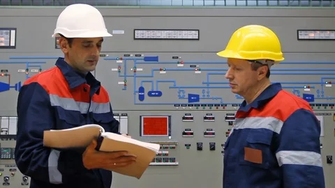 15 0511 TwoEngineersLookingLogsCloseup Stock Footage 105461836