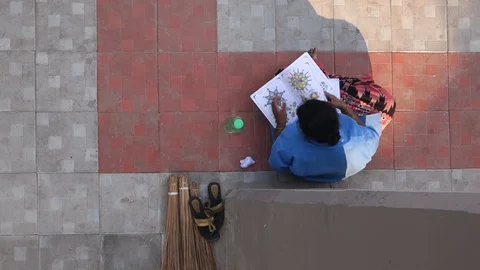 15-High-Angle-View-Sanitation-staff-employee-practices-drawing-during-a-break Stock Footage 89420501