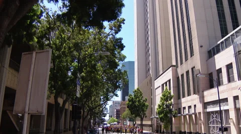 $15 per hour minimum wage protest crowd in street tilt down from building Stock Footage 62071386