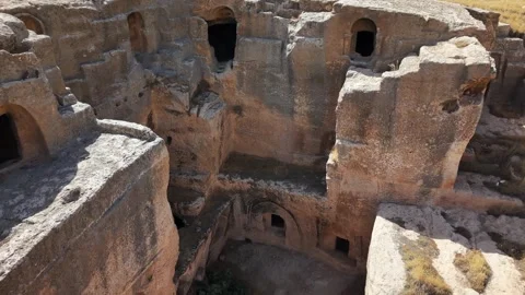 15-Second Cinematic Pullback from Ancient Cave Windows in Dara City Stock Footage 334794159