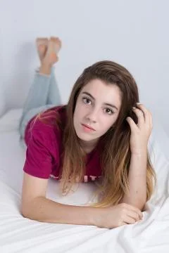 15-year-old adolescent lying on her bed Stock Photos