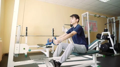 A 15-year-old boy with hearing impairment trains in the gym. The guy in the Stock Footage 87930088