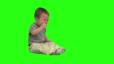 1.5 year old crying. Day clothes. Green background. Sitting Stock Footage 49864408