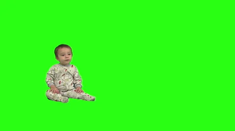 1.5 year old sits, stands, and walks offscreen right. Video stock 49864477
