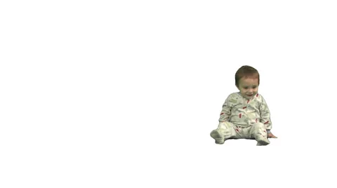 1.5 year old sits, stands, and exits screen left. Stock Footage 49864482