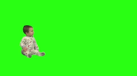 1.5 year old sits, stands, and walks offscreen right. Stock Footage 49864483