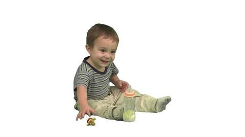 1.5 year old sitting, then putting pacifier in his mouth. White background. Stock Footage 49864396