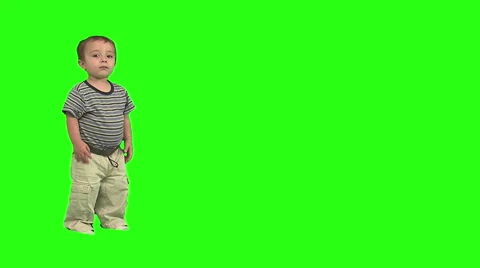 1.5 year old standing and walks offscreen right. Green background. Stock Footage 49864419