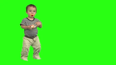 1.5 year old standing then drinks from bottle. Green background. Stock Footage 49864402