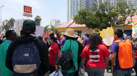 $15.00 per hour crowd of protesters in front of a McDonalds in San Diego Stock Footage 62403330