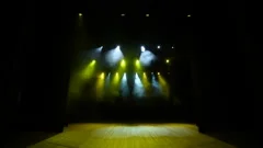Free stage with yellow lights, lighting devices, smoke fog.