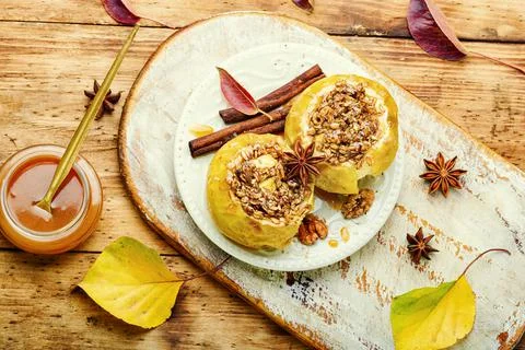 Baked apples stuffed with granola and nuts.Baking concept xkwx apple baked stuffed fruit dessert caramel syrup stuffed apple sweetness stuffed apples nut dessert autumn oatmeal filled food fruit baked apple sweet cinnamon plate delicious fall sugar walnut tasty bake caramel season dish syrup sauce eat prepared cinnamon stick scoop fallen leaves seasonal food kitchen board tempting granola appetizing rustic wooden background wooden table