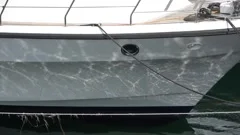 Close up view at a yacht with light reflecting from the water surface