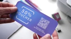 Holding a Rebate Shopping Voucher With QR Code