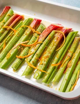 A  closeup  shot  of  rhubarb  stalks  in  a  rectangle  plate. xkwx closeup,  rhubarb,  stalks,  stems,  food,  fresh,  vegetarian,  organic,  meal,  dish,  dinner,  cuisine,  delicious,  prepared,  healthy,  plant,  vitamin,  ingredient,  edible,  green,  species,  colors,  cooking
