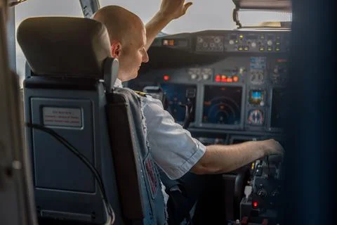 Focused professional pilot sitting in an airplane cabin, ready for takeoff. Aircraft, aircrew, occupation concept xkwx background, business, person, man, pilot, plane, aircraft, aviator, cabin, commercial, people, job, crew, flight, airliner, airplane, fly, professional, ready, transport, transportation, travel, uniform, work, service, sitting, attractive, focused, preparing, guy, journey, occupation, tourism, trip, adults, auto pilot, airport, adult, simulator, cockpit, real, air, takeoff, airline, landing, boarding, horizontal