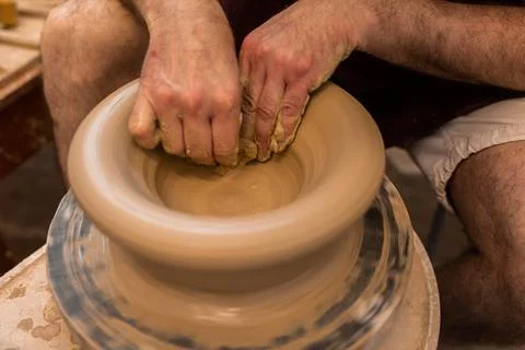 Crop unrecognizable sculptor with equipment giving shape while sculpting with brown clay on throwing wheel xkwx man, shape, clay, sculpt, equipment, process, motion, jug, ceramic, skill, male, sculptor, workshop, art, artist, handicraft, earthenware, ceramist, craft, create, dirty, form, hobby, handmade, maker, master, molding, occupation, pottery, utensil, wet, wheel, professional, work, artisan, throw, small business, talent, workplace, crop, unrecognizable, faceless, anonymous, horizontal, body part, blur, indoors, top view, from above