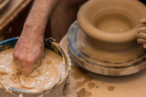 Crop unrecognizable sculptor with equipment giving shape while sculpting with brown clay on throwing wheel xkwx man, shape, clay, sculpt, equipment, process, motion, jug, ceramic, skill, male, sculptor, workshop, art, artist, handicraft, earthenware, ceramist, craft, create, dirty, form, hobby, handmade, maker, master, molding, occupation, pottery, utensil, wet, wheel, professional, work, artisan, throw, small business, talent, workplace, crop, unrecognizable, faceless, anonymous, horizontal, body part, blur, indoors, top view, from above