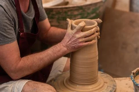 Crop unrecognizable sculptor with equipment giving shape while sculpting with brown clay on throwing wheel xkwx man, shape, clay, sculpt, equipment, process, motion, jug, ceramic, skill, male, sculptor, workshop, art, artist, handicraft, earthenware, ceramist, craft, create, dirty, form, hobby, handmade, maker, master, molding, occupation, pottery, utensil, wet, wheel, professional, work, artisan, throw, small business, talent, workplace, crop, unrecognizable, faceless, anonymous, horizontal, body part, blur, indoors