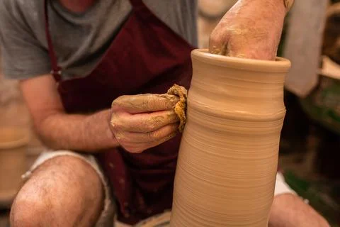 Crop unrecognizable sculptor with equipment giving shape while sculpting with brown clay on throwing wheel xkwx man, shape, clay, sculpt, equipment, process, motion, jug, ceramic, skill, male, sculptor, workshop, art, artist, handicraft, earthenware, ceramist, craft, create, dirty, form, hobby, handmade, maker, master, molding, occupation, pottery, utensil, wet, wheel, professional, work, artisan, throw, small business, talent, workplace, crop, unrecognizable, faceless, anonymous, horizontal, body part, blur, indoors
