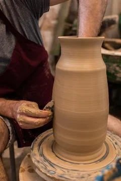 Crop unrecognizable sculptor with equipment giving shape while sculpting with brown clay on throwing wheel xkwx man, shape, clay, sculpt, equipment, process, motion, jug, ceramic, skill, male, sculptor, workshop, art, artist, handicraft, earthenware, ceramist, craft, create, dirty, form, hobby, handmade, maker, master, molding, occupation, pottery, utensil, wet, wheel, professional, work, artisan, throw, small business, talent, workplace, crop, unrecognizable, faceless, anonymous, horizontal, body part, blur, indoors