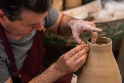 Crop unrecognizable sculptor with equipment giving shape while sculpting with brown clay on throwing wheel xkwx man, shape, clay, sculpt, equipment, process, motion, jug, ceramic, skill, male, sculptor, workshop, art, artist, handicraft, earthenware, ceramist, craft, create, dirty, form, hobby, handmade, maker, master, molding, occupation, pottery, utensil, wet, wheel, professional, work, artisan, throw, small business, talent, workplace, crop, unrecognizable, faceless, anonymous, horizontal, body part, blur, indoors