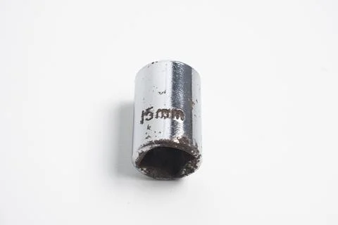 A 15mm socket made of chrome-plated steel, showing signs of wear and rust. .. 写真素材