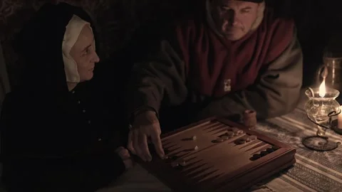 15th century couple playing 'tables' or backgammon by oil lamp #1 Stock Footage 320537963